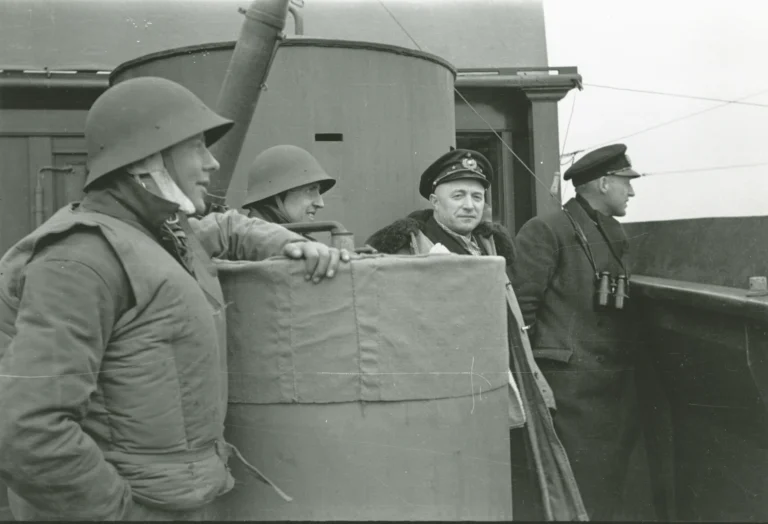 Archival wartime photograph of men on the deck of a ship.