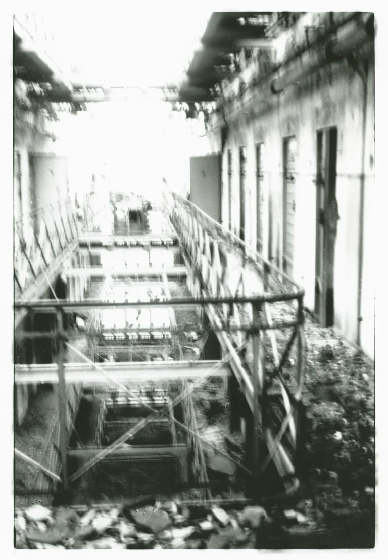 Archival photograph of damaged buildings connected to Sonnenburg prison history.